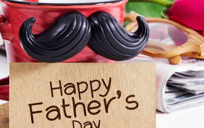 Red Bud Laundry Company Father's Day celebration with a decorative mug featuring a mustache, a "Happy Father's Day" card, and a rose, symbolizing appreciation and fresh looks for dads.